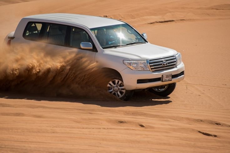 El Farissi Journey Toyota Land Cruiser drifting over Sahara dunes